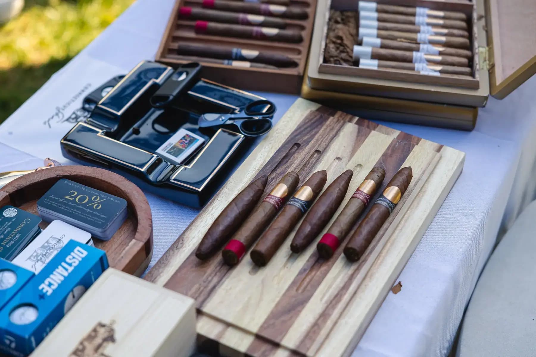 Close-up of a table of cigars, cigar boxes and lighters