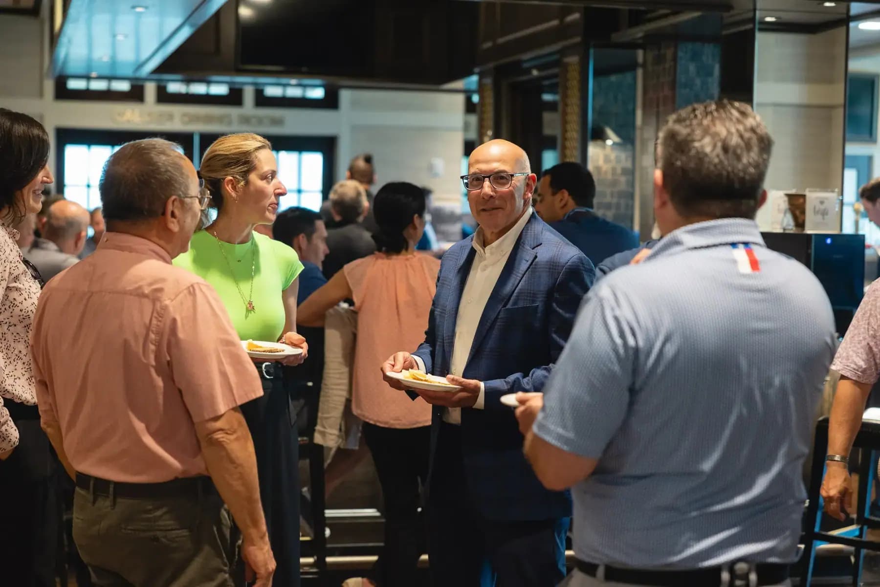 Guests mingling and talking in the clubhouse