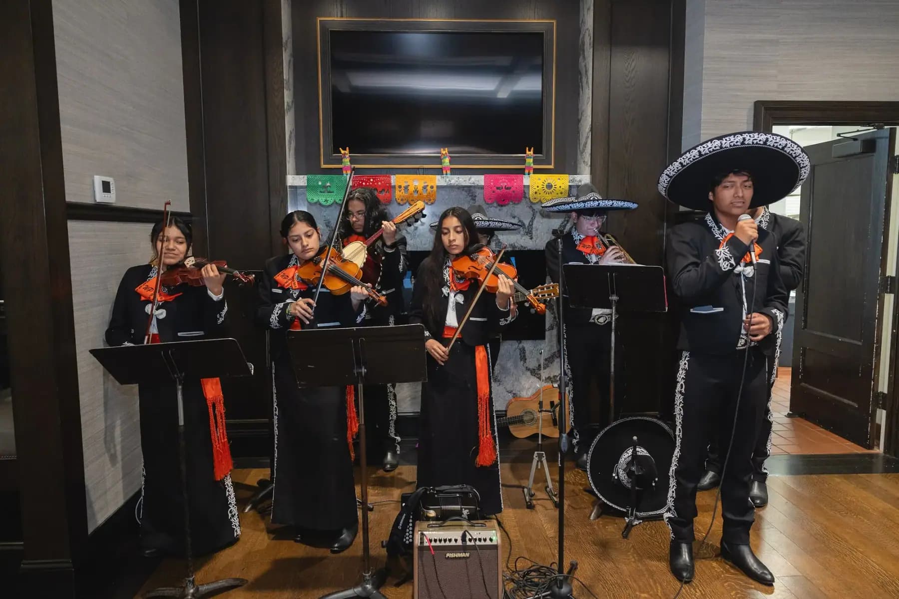 Mariachi musicians playing violins on music stands