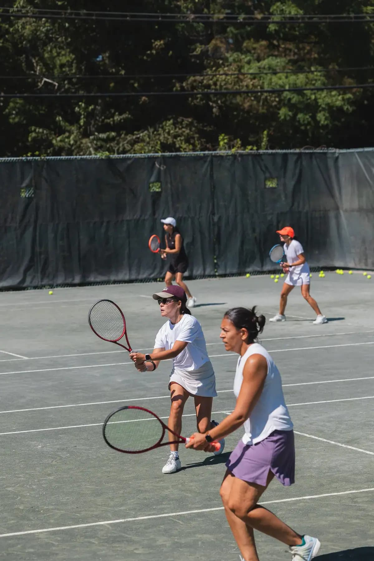 Doubles players moving toward the net during a rally