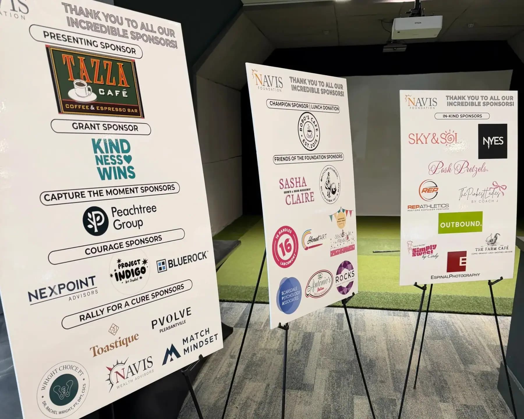 Sponsor thank-you boards on easels, with Tazza Cafe as presenting sponsor