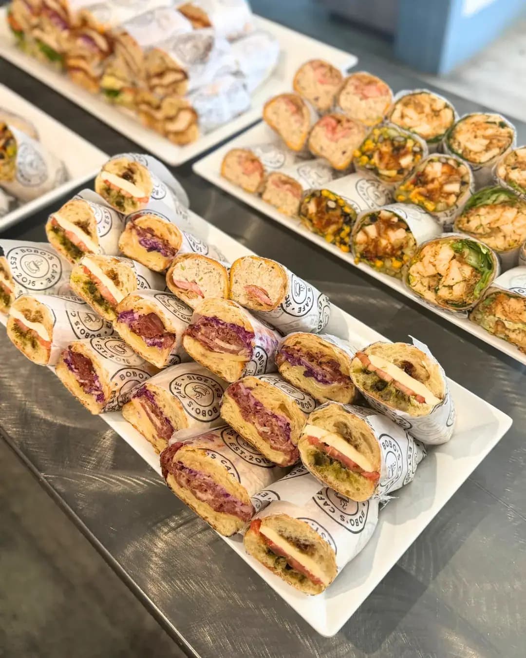 Platters of wrapped sandwiches